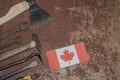 Labor Day in Canada, May 1. Lots of handy tools on old rusty background with Canada flag with copy space Royalty Free Stock Photo