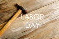 Labor day concept. Hammer on wooden background