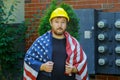 Labor day concept for worker in a yellow helmet with an American flag Royalty Free Stock Photo