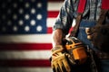 Labor Day representation Gloved laborer, toolbelt, measure against US flag background