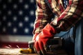 Labor Day representation Gloved laborer, toolbelt, measure against US flag background