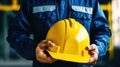 Labor Day. The worker holds a helmet in his hands.