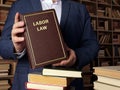 LABOR LAW book in the hands of a attorney. Labor law primarily concerns the rights and responsibilities of unionized employees Royalty Free Stock Photo
