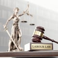 Labor Law: Judge& x27;s Gavel as a symbol of legal system, Themis is the goddess of justice and wooden stand with text