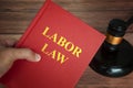 Labor law text on law book with judge gavel on wooden desk background. Royalty Free Stock Photo
