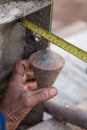 Labor man using a plumb bob for check pillar Royalty Free Stock Photo