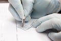 Laboratorian labelling a microscope slide using a diamond tip pencil. Laboratorian giving admission to pap smear samples in the