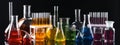 Laboratory analysis. Different glassware with colorful liquids on black background, banner design Royalty Free Stock Photo