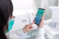 Laboratory analysis finding on smart phone app in nurse hands concept