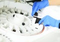 laboratory assistant in blue rubber gloves adds a reagent to the centrifuge of a modern biochemical analyzer. Royalty Free Stock Photo