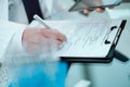 laboratory assistant with a digital tablet filling out a medical form. Royalty Free Stock Photo