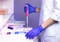 A laboratory assistant (doctor) in a clinical laboratory examines blood for clotting (homeostasis analysis).