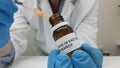 Laboratory assistant filling the syringe with Covid-19 vaccine from a vial