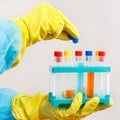 Laboratory assistant hands in rubber gloves is conducting chemical experiments in laboratory