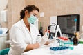 Laboratory assistant holds test tubes for gynecological and cytological analysis. Woman scientist working in medical lab Royalty Free Stock Photo