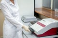 Laboratory assistant loads samples into the apparatus for analysis, side view Royalty Free Stock Photo