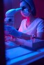 Laboratory assistant in protective gloves conducts an ICSI procedure