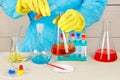 Laboratory assistant in rubber gloves doing chemical analysis in laboratory