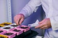 A laboratory assistant& x27;s hand holds a corn seed in tweezers, and corn seeds in a petri dish are decorated with Royalty Free Stock Photo