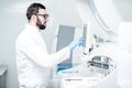Laboratory assistant working with medical analizer machine Royalty Free Stock Photo