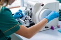 Laboratory assistant works on a rotary microtome section and making microscope slides