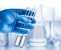 Laboratory beakers in analyst\'s hand in plastic glove Royalty Free Stock Photo