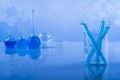 Laboratory beakers, microscope, blue background Royalty Free Stock Photo