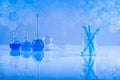 Laboratory beakers, microscope, blue background Royalty Free Stock Photo