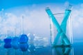 Laboratory beakers, microscope, blue background Royalty Free Stock Photo