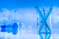 Laboratory beakers, microscope, blue background Royalty Free Stock Photo