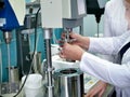 Laboratory on chemical production. Laborandi put the experience. The hands of the person doing the experiment