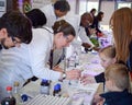 Laboratory chemists tak a day out of the lab to teach children about chemistry as part of the UK STEM, science, technology,engine Royalty Free Stock Photo