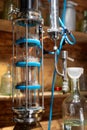Laboratory distillation apparatus with glass components and blue accents. The setup includes a condenser and various glass Royalty Free Stock Photo