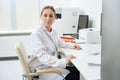 Laboratory employee is sitting at her desk