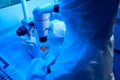 Laboratory employee in a sterile room performs biopsy of embryos