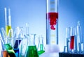 Laboratory equipment, bottles filled with colorful liquids, red liquid reacted