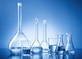 Laboratory equipment, bottles, flasks on blue background Royalty Free Stock Photo