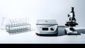 Laboratory Equipment Centrifuge, Microscope, Test Tubes, and Flask on White Background Royalty Free Stock Photo