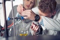 Laboratory equipment for distillation.Student/intern/technician's hands showing experiment.Working in teams for a better result.Sc