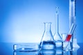 Laboratory equipment, glass flasks, pipettes, red liquid