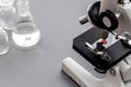 Laboratory examination with microscope. Equipment on grey background