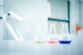 Laboratory flask with colorful liquids stirred inside in laboratory Royalty Free Stock Photo