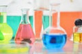 Laboratory flasks and beakers with liquids of different colors on lab table Royalty Free Stock Photo