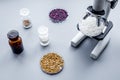 Laboratory for food analysis. Rice under the microscope on grey background