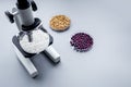 Laboratory for food analysis. Rice under the microscope on grey background copyspace