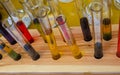 Laboratory glass tubes with colored liquids on a wooden stand Royalty Free Stock Photo