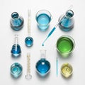 Laboratory glassware arranged on a white surface includes beakers, flasks, Royalty Free Stock Photo