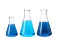Laboratory glassware with blue liquids on white