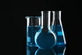 Laboratory glassware with blue liquids