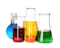 Laboratory glassware with colorful liquids on white background Royalty Free Stock Photo
